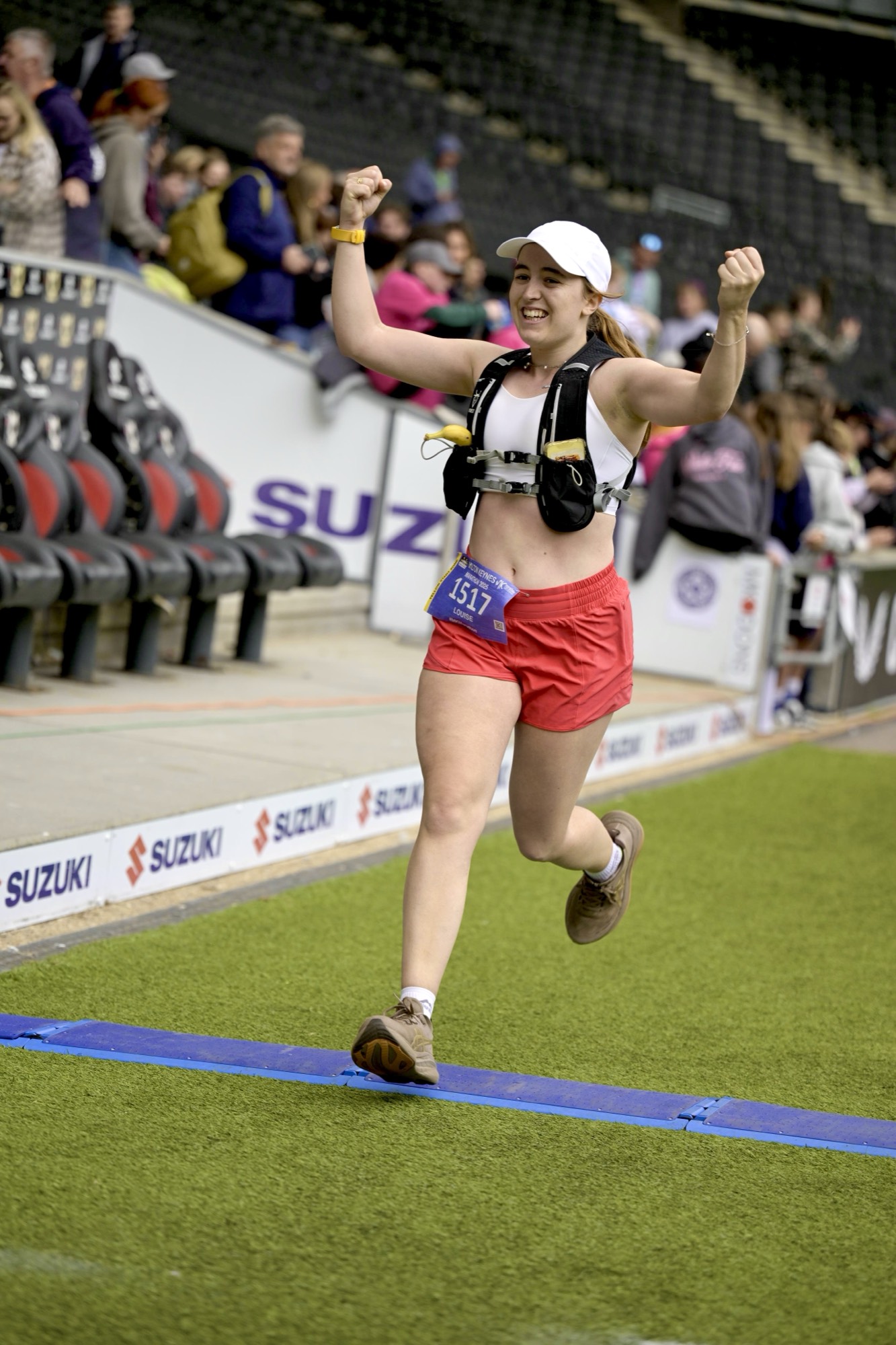 Louise Holden celebrating at a marathon finish line
